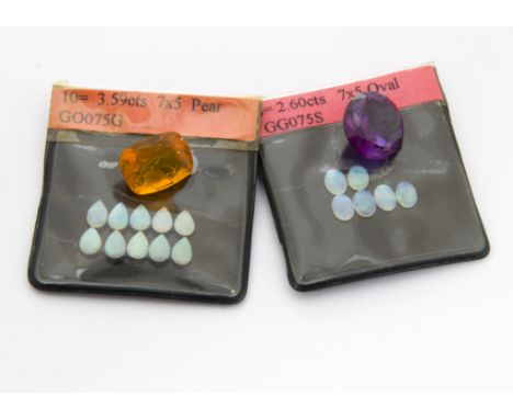 A collection of loose stones, including a cushion mixed cut fire opal, a synthetic colour change alexandrite and a quantity o