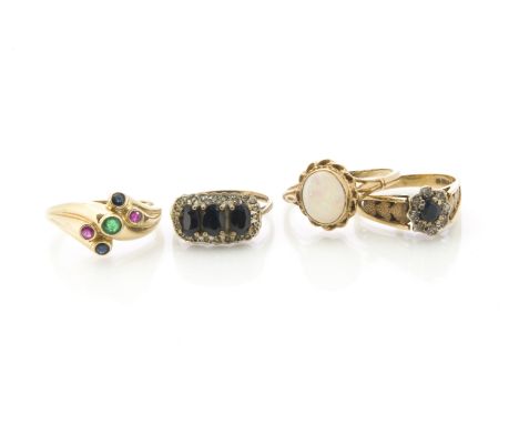 Four gem set gold rings, including two diamond and sapphire examples, a white opal dress ring and a sapphire, ruby and emeral