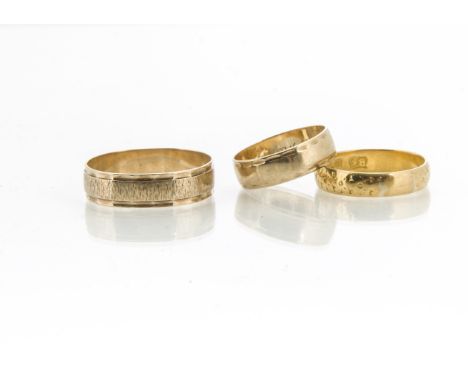 Three gold rings, comprising a 22ct gold Bravingtons wedding band with engraved decoration, approximate ring size R, 3.5g, to