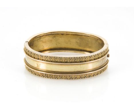 A Victorian gold bangle, oval form with one half plain, the other with neo-classical design, 23.3g, internally 5.8cm x 5.4cm 