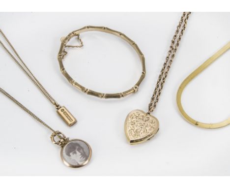 Five vintage and modern items of gold jewellery, including a bamboo bangle, a gold front and back heart locket on 9ct gold ch