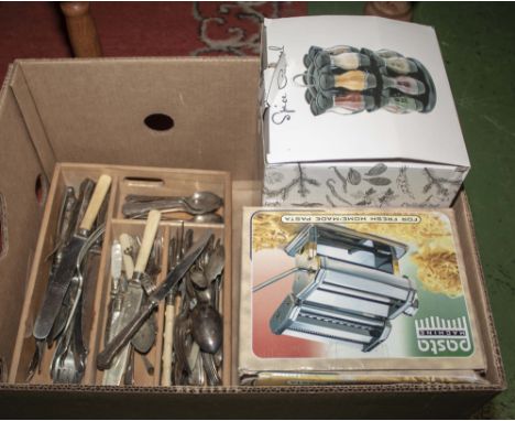 A spice rack, pasta maker and cutlery 