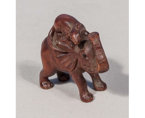 A wood netsuke, elephant and rat, signed