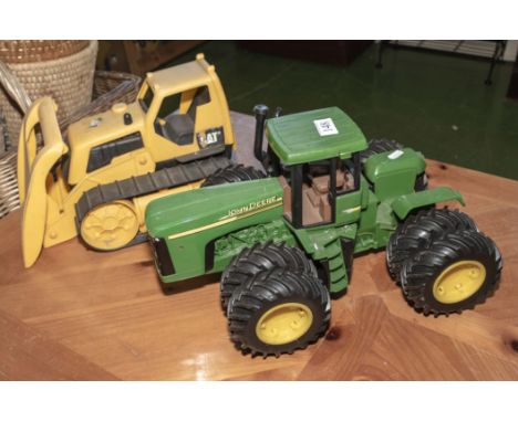 A toy bulldozer and a tractor