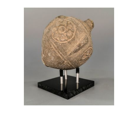 Ca.800 AD. A hollow ceramic vessel with the barrel-shaped body; domed top and conical base; the body with a latticework desig