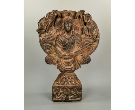 Ca.200 AD. Very Rare Gandhara carved schist stone panel illustrating a seated Buddha Shakyamuni in a lotus flower; in the low