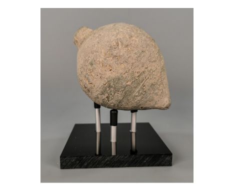 Ca.800 AD. A hollow ceramic vessel with a barrel-shaped body; domed top; conical base;knop to the upper face for the mouth; o