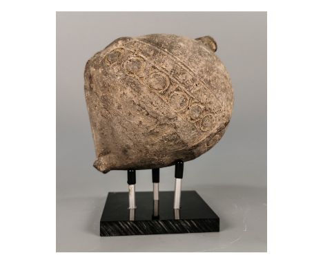 Ca.800 AD. A hollow ceramic vessel with a barrel-shaped body, domed top, and conical base, the body with a latticework design