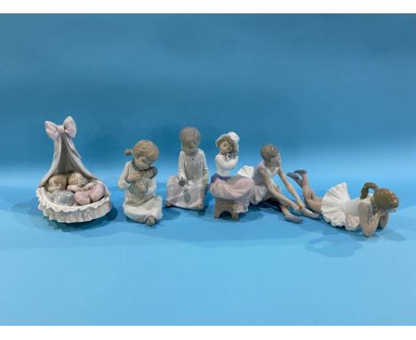 A Lladro group of two babies in a crib and five Nao figures