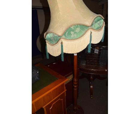 A pine standard lamp and fringed shade