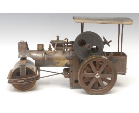 A mid-century brass model, of a steam road roller, offside rear wheel commanded by cogs and piston, the front wheels turning 