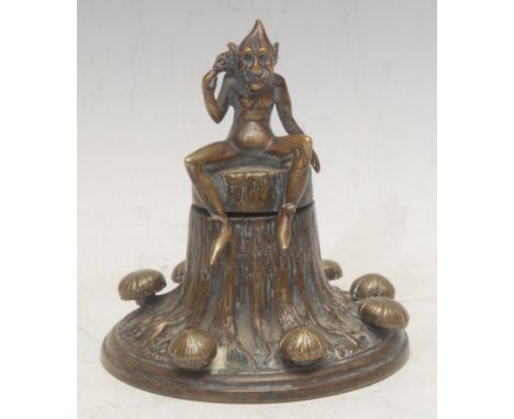 A 19th century bronze novelty inkwell, cast as a pixie seated on a tree stump, within a band of mushrooms, 12cm high, c.1890