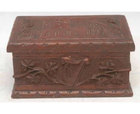 An Irish oak rectangular box, carved with a harp and a view of Muckross Abbey, County Kerry, hinged cover, 15cm wide, early 2