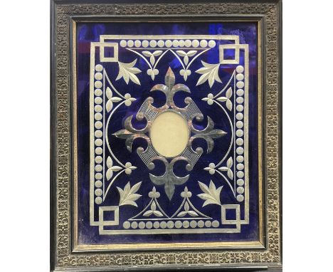 A 19th century Bohemian silver coloured metal over-layed easel picture frame, elaborately decorated with fleur-de-lis among v