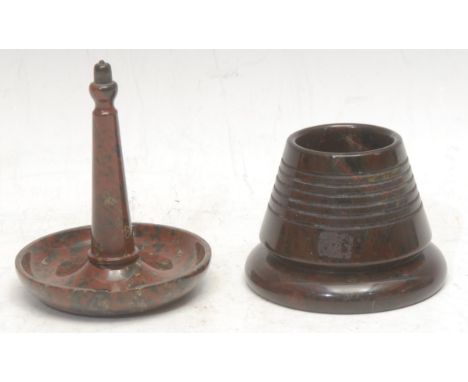 A Cornish serpentine ring stand, dished base, 9.5cm high, c.1900; a match striker or table vesta, 6cm high, c.1900 (2)