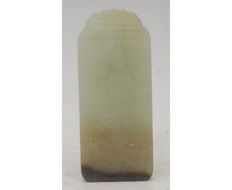 A Chinese jade tablet, carved in relief with Guanyin standing on a dragon, 8cm long