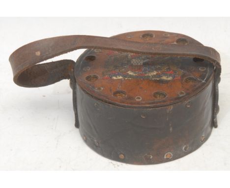 An early 20th century leather fuse or ordnance carrier, decorated in polychrome with Royal coat of arms, 11.5cm diam
