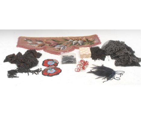 A Berlin beadwork fringed panel, consisting of rocaille beads, embroidered with flowers on a pink ground, 52cm wide; assorted