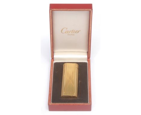 A Cartier gold plated cigarette lighter,serial no. 105048, 7cm long, boxed