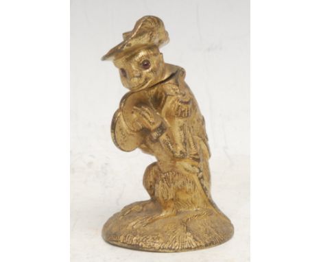 A 19th century gilt metal novelty table vesta, ccast as a monkey dressed in a Napoleonic military uniform, hinged cover, glas