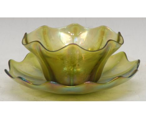 An Art Nouveau Loetz style glass bowl on stand, wavy rim, painted in mottled tones of iridescent green and purple, 8cm high o