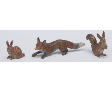 An Austrian cold painted bronze, of a fox, 10cm long, c.1900; others, a rabbit; a squirrel (3)