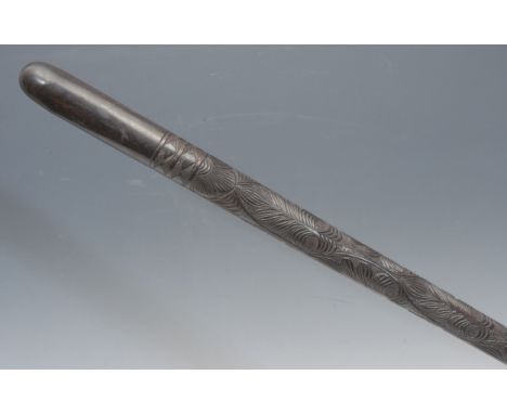 An early 20th century Anglo-Indian ebony walking stick, the cane carved with stylised palmettes, the domed pommel quite plain