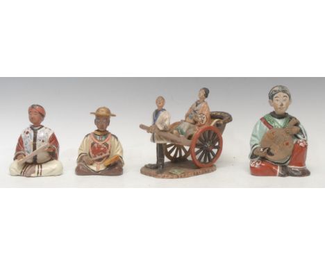 A Chinese earthenware nodding head figure group, as a lady riding in a rickshaw, both the puller and lady with nodding head, 
