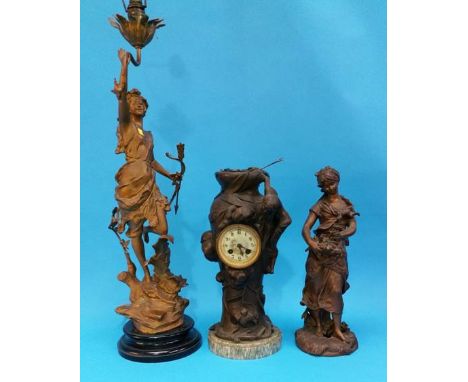 A Spelter clock group, a Spelter figural table lamp and another figure.