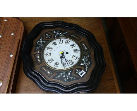 Continental wall clock in ebonised frame and inlaid with mother of pearl.