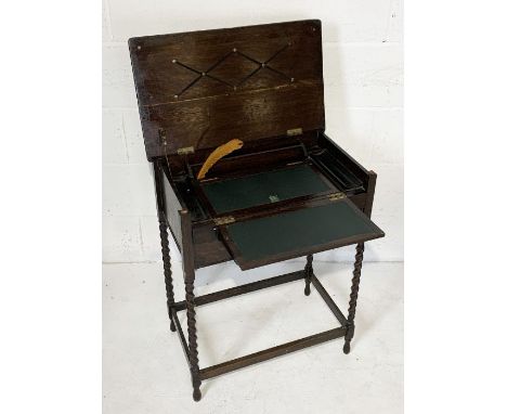 A vintage writing cabinet on barley twist legs with fold out leather desk and box below