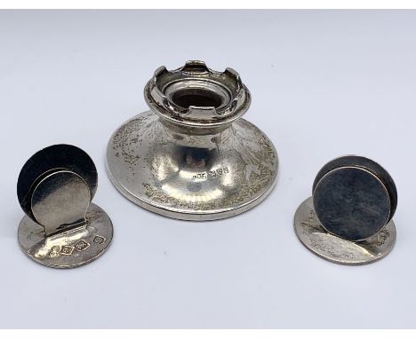 A hallmarked silver inkwell with castellated top along with two silver menu holders