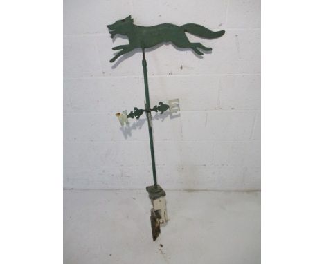An antique wrought iron weather vane depicting a fox