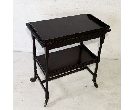 A vintage mahogany metamorphic tea trolley/card table