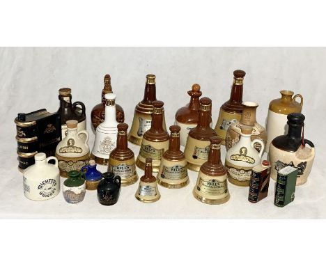 A collection of various ceramic whisky decanters including Bell's etc.