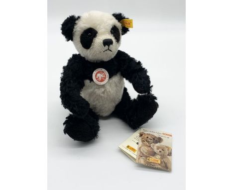 A Steiff mohair panda bear with original gold button and labels 