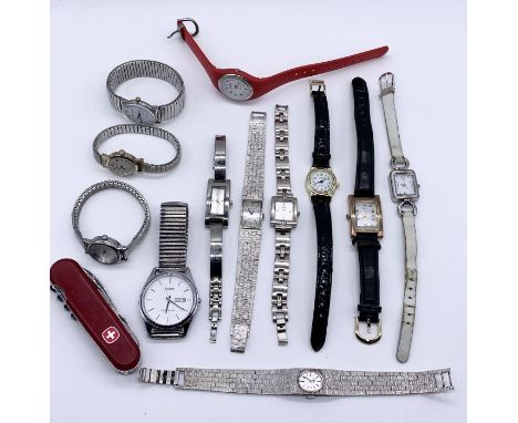 A collection of watches along with a Swiss Army style penknife