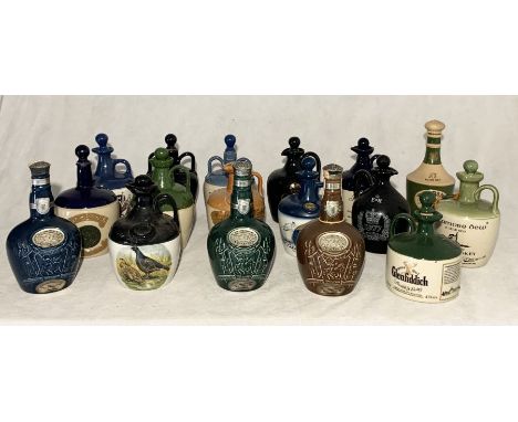 A collection of various ceramic whisky decanters including Spode, Montrose Potteries etc. 