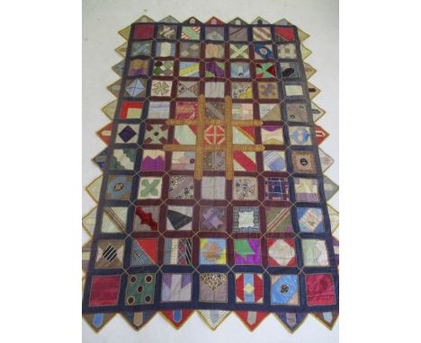 A richly coloured patchwork style wall hanging/bed spread