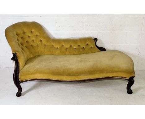 A Victorian button back rosewood chaise lounge upholstered in yellow velvet with scrolled feet