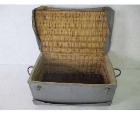 A vintage canvas covered wicker basket
