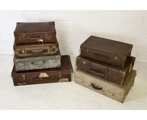 A collection of seven vintage travel trunks and suitcases