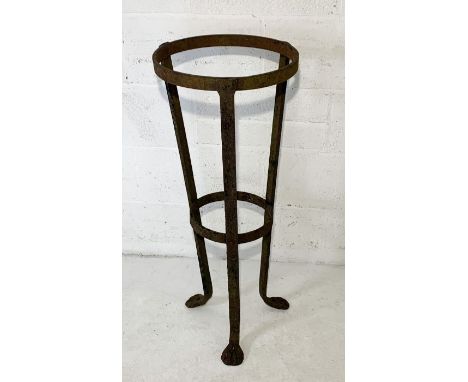 A wrought iron plant stand on tripod legs and formed feet H