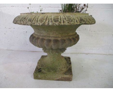 A stone planter on plinth