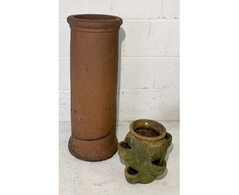 A terracotta chimney pot along with a strawberry planter 