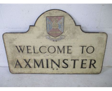 A vintage cast metal sign "Welcome to Axminster"