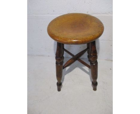 A vintage elm stool with cross stretchers