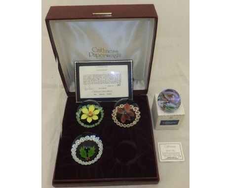 A collection of four Caithness glass paperweights comprising three of the "Four Seasons", designed by Colin Terris and made b