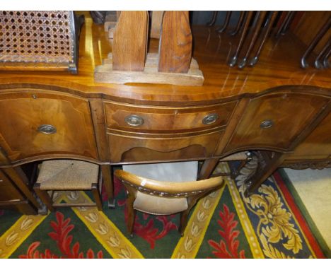 A reproduction mahogany serpentine fronted sideboard, a Victorian walnut low salon chair, two string seat stools, two nests o