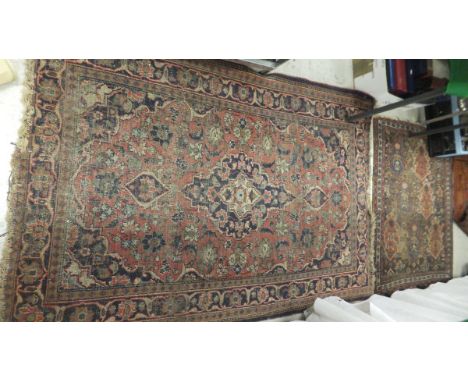 A Caucasian rug with repeating medallions and animal motifs on a dark brown ground, within a  triple stylised ribbon decorate